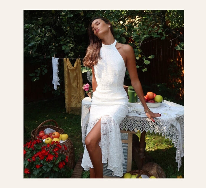 A silhouetted midi dress with a lace back
